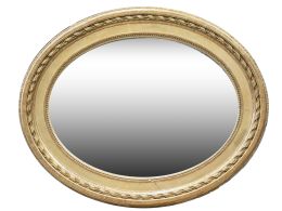 1242.  Espejo oval de madera tallada, estucada y dorada.España, h. 1900.