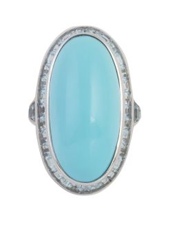 254.  Sortija con gran cabuchón oval de turquesa, orlado de topacios azules talla carré