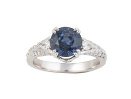 319.  Sortija con zafiro circular de 2,87 ct flanqueado por diamantes talla pera, y con brazos de la montura decorados por brillantes 