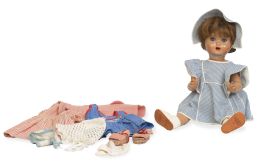 1206.  Mariquita Pérez.Muñeca de cartón piedra con ojos durmientes y vestido de cuadros azules y blancos.España, h, 1940.