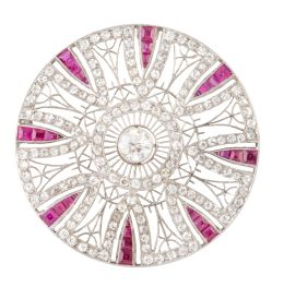 409.  Elegante broche- colgante Art-Decó circular, con decoración