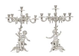 1393.  Pareja de candelabros de metal plateado de seis luces, con puttis en el fuste.Principios del S. XX.