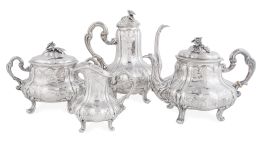 1063.  Juego de café y té de plata con decoración grabada y repuja