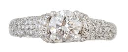 205.  Solitario con brillante central de 0,60 ct engastado en garras, sobre montura cuajada de brillantes 