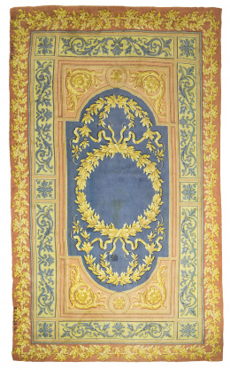 1093.  Alfombra en lana de campo naranja y cartela con hojas.Firmada M. Stuyck, 1950.