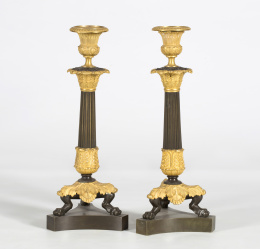 706.  Pareja de  candeleros en bronce  dorado y pavonado,  con patas de garra de león de estilo Carlos X. Francia, S. XIX.