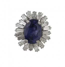 563.  Sortija con  zafiro natural de talla oval ,probablemente de Ceylán,en orla de diamantes talla marquisse y baguette trapezoidal engastadas a diferentes alturas