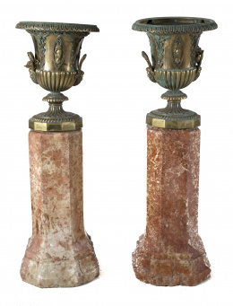 1022.  Pareja de ánforas de bronce dorado, con aplicaciones de musas, en cartelas y hojas S. XIXSobre pareja de columnas de mármol, S. XVIII - XIX.