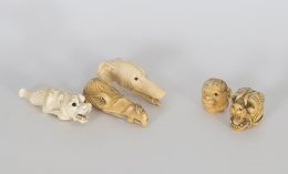 734.  Cabeza de mono y de perroDos mangos para bastón de marfil tallado, ff. del S. XIX - pp. del S. XX.