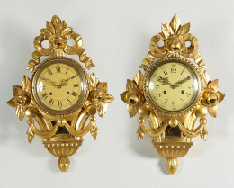 1102.  Pareja de relojes de estilo Luis XVI de madera tallada y dorada.Trabajo Sueco, S. XIX.
