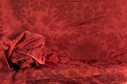 1065.  Dos fragmentos de damasco rojo con flores, pp. del S. XX..