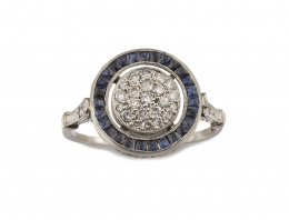 684.  Sortija con centro de pavé de brillantes orlado de zafiros calibrados .