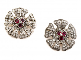 55.  Pareja de broches de pp.S XX en forma de flor con tríos centrales de rubíes y perlitas finas y pétalos cuajados de brillantes