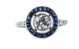 182.  Sortija ojo de perdiz con brillante de 0,65 ct orlado de zafiros