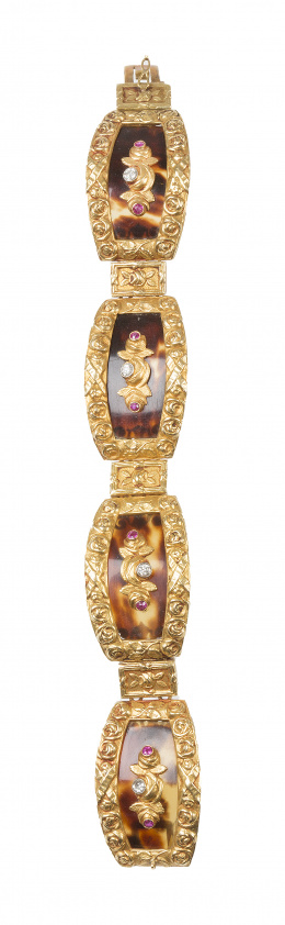 71.  Brazalete de ff. S. XIX con cuatro motivos de carey en marco de motivos florales, con centro de rosas de brillante y rubíes