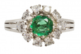 700.  Sortija con esmeralda central de 1 ct de talla redonda, orlada de brillantes