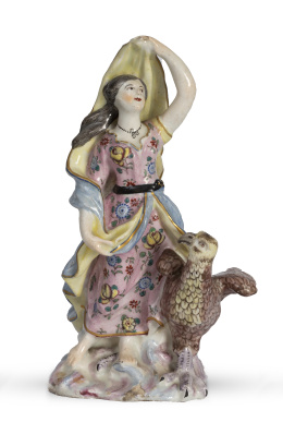 1134.  Figura escultórica femenina con ave de porcelana esmaltada,Posiblemente Inglaterra, h. 1800.