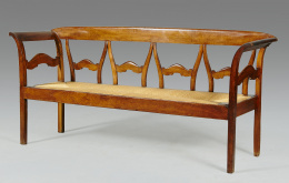 1003.  Canapé de cuatro plazas en madera de nogal con asiento de enea.Trabajo mallorquin, S. XIX.