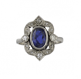 122.  Sortija lanzadera de pp.S.XX con zafiro sintético central enmarcado por ondas de brillantes 