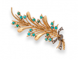 84.  Broche rama de turquesas con nervio central de cordoncillo de oro. En oro amarillo de 18K . 