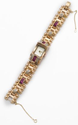 91.  Reloj ASCOT años 40 con diseño chevaliêre de piezas geométricas articuladas adornadas con brillantes y rubíes sintéticos.