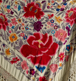 1082.  Mantón de “Manila” en seda con flores bordadas de color con peonías y flores, flecos grandes de macramé.Trabajo cantonés, pp. del S. XX.