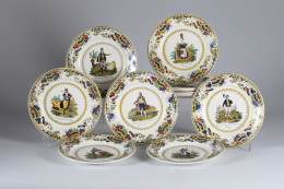 1144.  Juego de once platos de loza estampada de Creill, con decoración de tipos populares españoles y cenefa de flores y pájaros.Francia, S. XIX