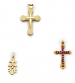 607.  Lote de dos cruces colgantes en oro de 18K.