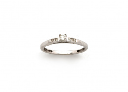 156.  Sortija con brillante de 0,12 ct y 6 carrés en la montura de oro blanco de 18K.