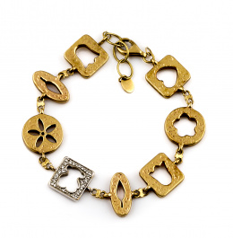 766.  Pulsera articulada TOUS con piezas con interior calado de motivos decorativos en oro amarillo de 18K, combinadas con piezas de oro blanco y brillantes con perfil de oso calado.