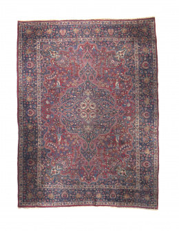 1025.  Alfombra en lana con campo rojo, con cartucho central y medallones, Persia.
