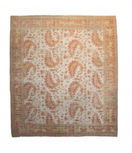 685.  Alfombra en lana en rosa, ocre y verde con decoración de cashmire y ciervos.España, pp. del S. XX..