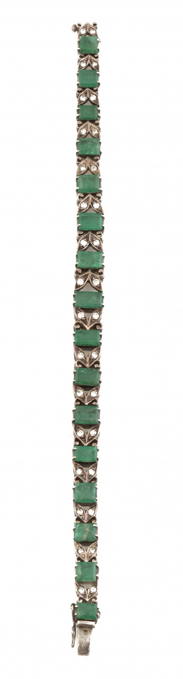 90.  Pulsera con esmeraldas de talla rectangular de tamaño creciente hacia el centro entre hojas con parejas de diamantes