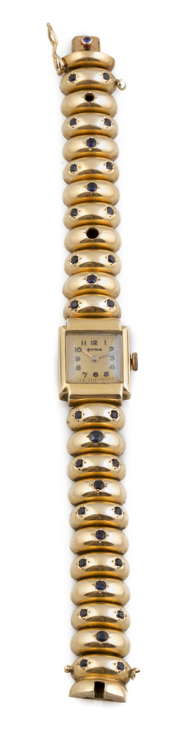425.  Reloj-joya CYMA años 40 con brazalete de arcos articulados en oro de 18K y zafiros