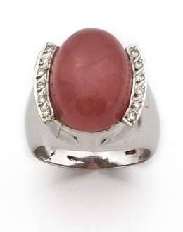 663.  Sortija con cabuchón de rodocrosita entre bandas de brillantes.