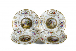 859.  Juego de cuatro platos de porcelana esmaltados y dorados, con escenas galantes y tondos y con ramilletes de flores.Meissen, S. XIX..