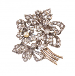 85.  Broche en forma de ramo  y cintas con flor central coronada por zafiro blanco