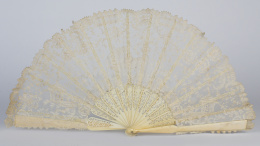 597.  Abanico con país bordado en blonda, padrones y varillaje calados simulando marfil.ffs. del S. XIX - pp. del S. XX.
