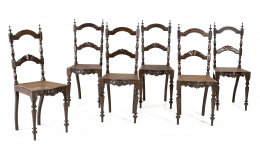 711.  Conjunto de seis sillas en madera de palosanto torneada y tallada con asiento de rejilla.Portugal, S. XIX.