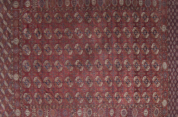619.  Alfombra Bukara de campo rojo y decoración geométrica