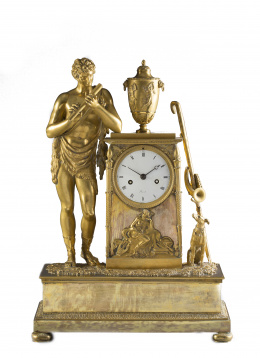1287.  Joseph Revel (1775-1828).Reloj de sobremesa imperio de bronce dorado, con la figura del Dios Pan. Firmado en la esfera "Revel".Trabajo francés, (1799-1815).