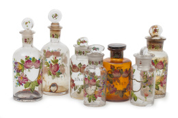 643.  Lote de siete frascos de cristal con decoración esmaltada con decoración floral, uno en cristal ocre, S. XIX