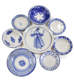 591.  Lote de ocho platos de cerámica, esmaltados en azul y blanco, uno decorado con dama vestida a la manera del S. XVII.Levante, S. XIX.