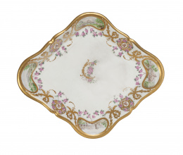 734.  Fuente romboidal de la vajilla de los Príncipes de Asturias, esmaltada y dorada. Sigue los modelos de la manufactura de Sévres. Con marca en azul en la base.Buen Retiro, (1775-1784).