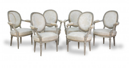 655.  Juego de seis sillas de brazos de estilo Luis XVI de madera tallada y lacada.S. XX.