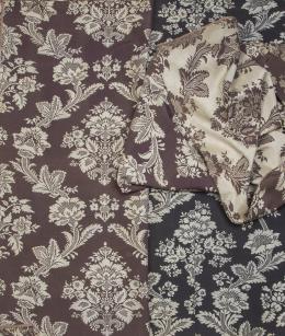 1215.  Lote de tres fragmentos con bordado sobre seda, dos de ellos en marrón y otro en negro, con motivos florales.S. XIX.