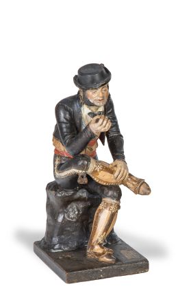 607.  José Cubero Gabardón (Baena 1818- Málaga 1877)."Bandolero sentado".Escultura en barro cocido y policromado sobre base de madera con etiqueta.