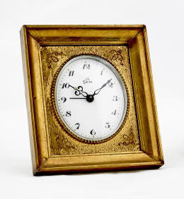 247.  Reloj de mesa “UTI  SWiza” con marco en bronce dorado.