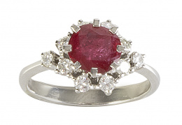 406.  Sortija con un rubí de 1 ct con talla redonda, orlado de brillantes , y con brillantes como remate de los brazos de la montura