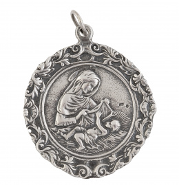 56.  Medalla de cuna con Virgen y Niño rodeados por marco floral